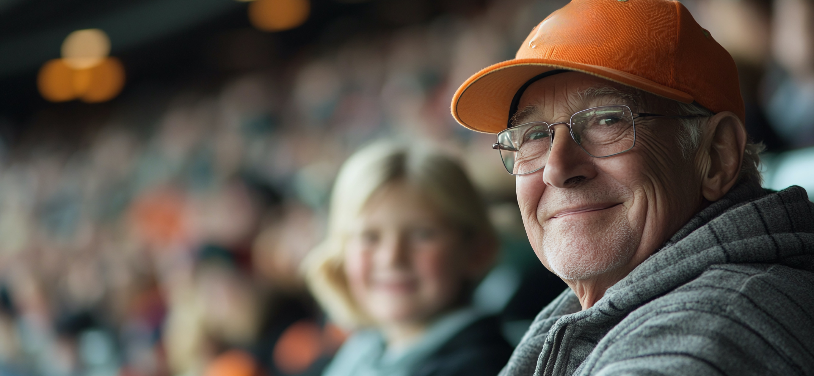 Man and grandchild watching a Super Bowl game.